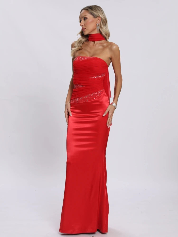 Elegant strapless red dress with mesh patchwork and matching scarf.